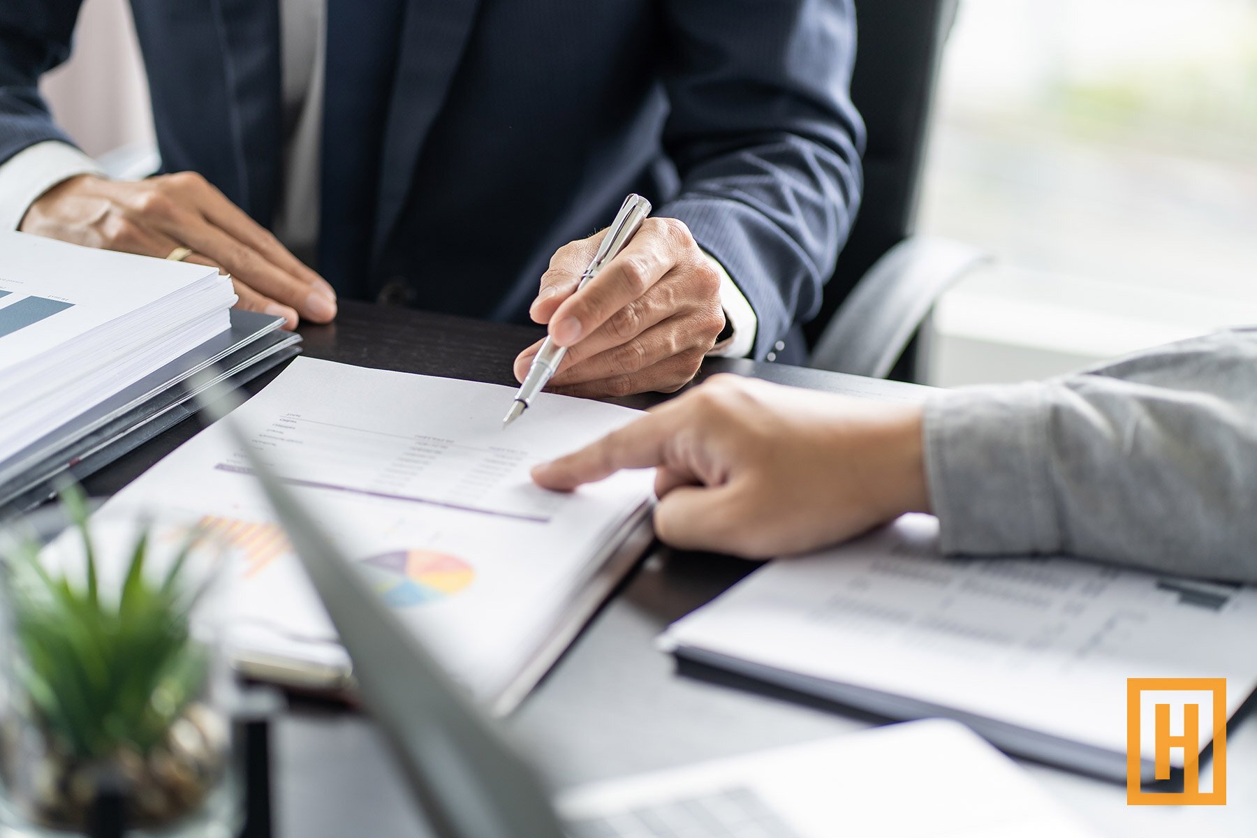 two investors reviewing data on paper